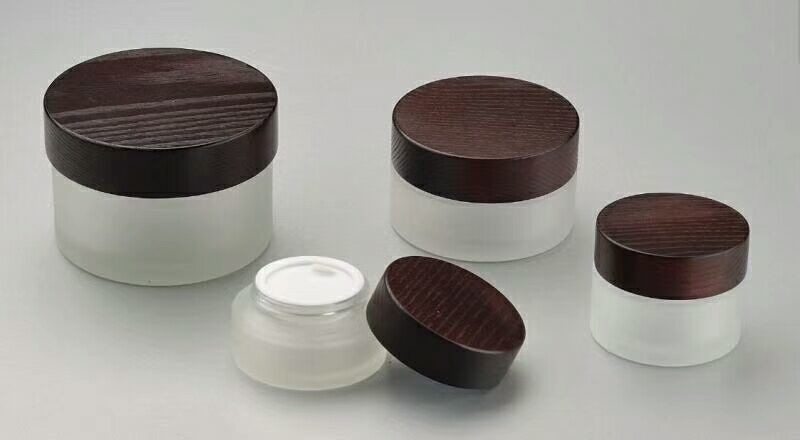 Download 100g frosted glass cosmetic cream jar with solid wooden ... Yellowimages Mockups